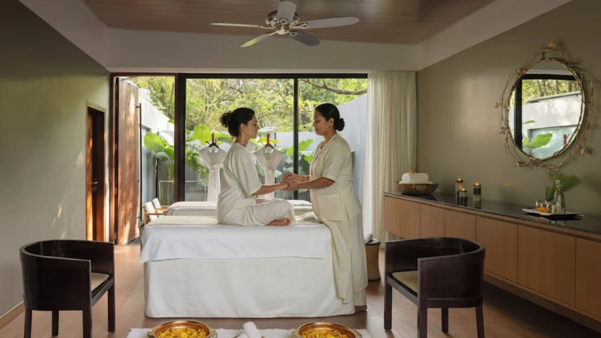 Ayurvedic doctor performing traditional pulse diagnosis on guest.