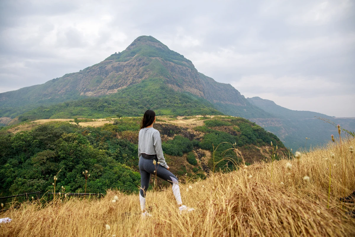 Guest practicing outdoor fitness in the Sahyadri mountain landscape.