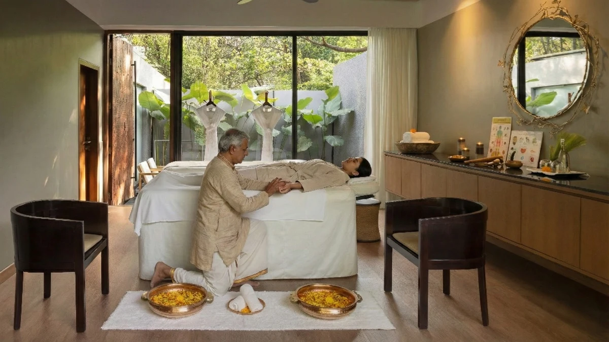 Ayurvedic practitioner performing pulse diagnosis on guest's wrist.