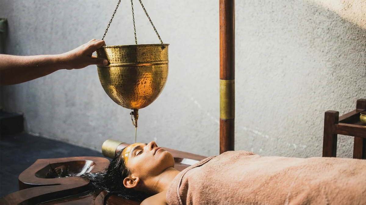 Shirodhara treatment with warm oil stream