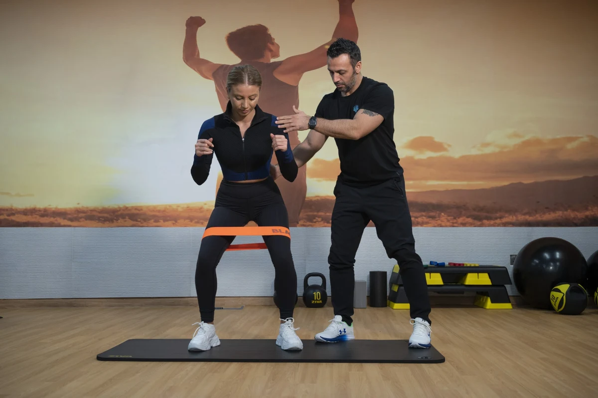 Experienced physiotherapist guiding personalized rehabilitation exercises with patient.